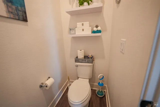 a white toilet sitting next to a small sink