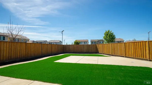a view of a backyard with wooden fence