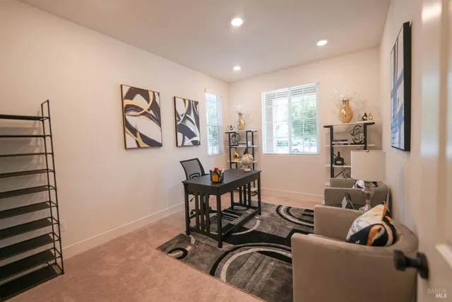 a living room with furniture a window and a painting on the wall