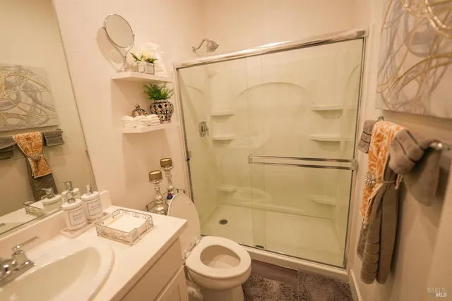 a bathroom with a sink toilet and shower