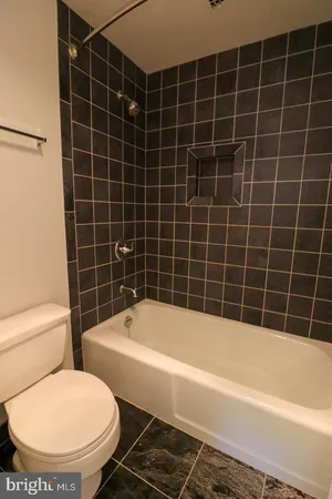 a white bath tub sitting next to a white toilet