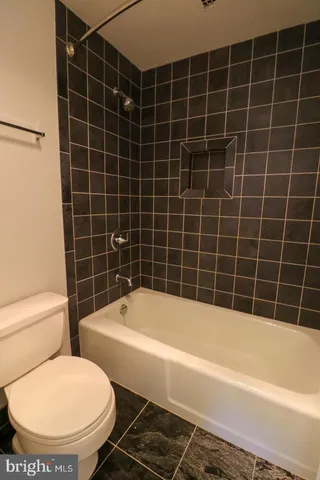 a white bath tub sitting next to a white toilet