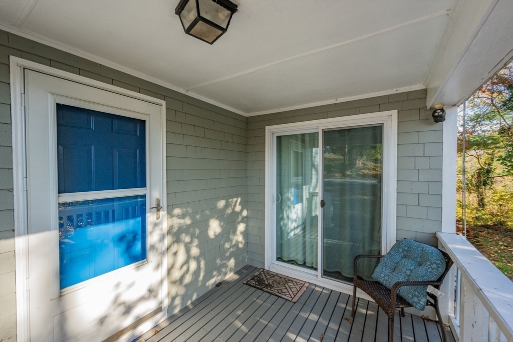 78 Puritan Road Bourne, MA 02532 - Photo 5 of 34 a view of a balcony with furniture and floor to ceiling window