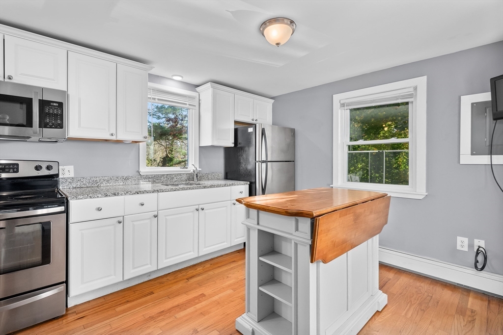 78 Puritan Road Bourne, MA 02532 - Photo 8 of 34 a kitchen with stainless steel appliances granite countertop a stove a sink and a refrigerator