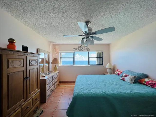 a bathroom with a toilet and a painting on the wall