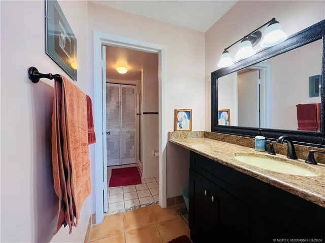 a bathroom with a sink vanity mirror and toilet