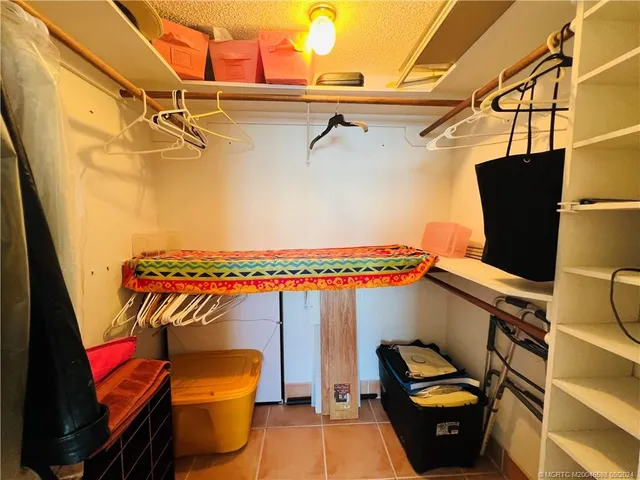 a bedroom with two beds and a potted plant