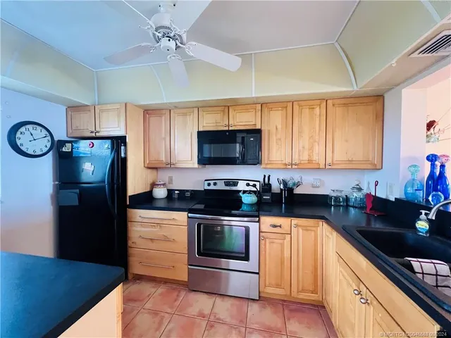 a kitchen with stainless steel appliances a stove a microwave and a refrigerator