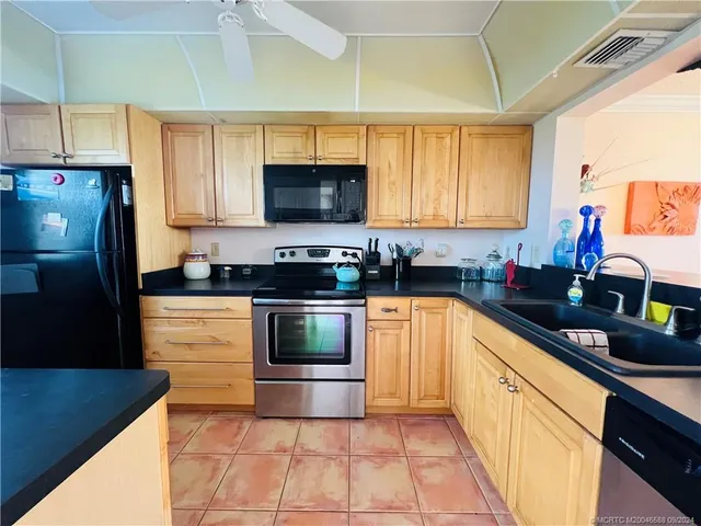a kitchen with stainless steel appliances a stove sink microwave and cabinets