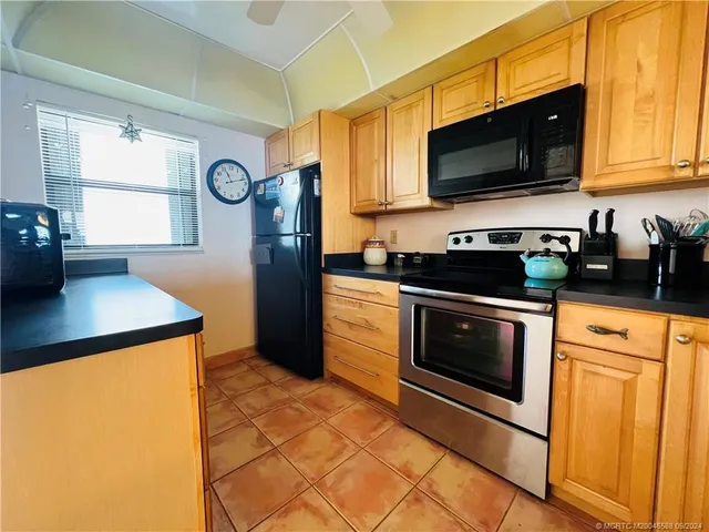 a living room with furniture and a kitchen view