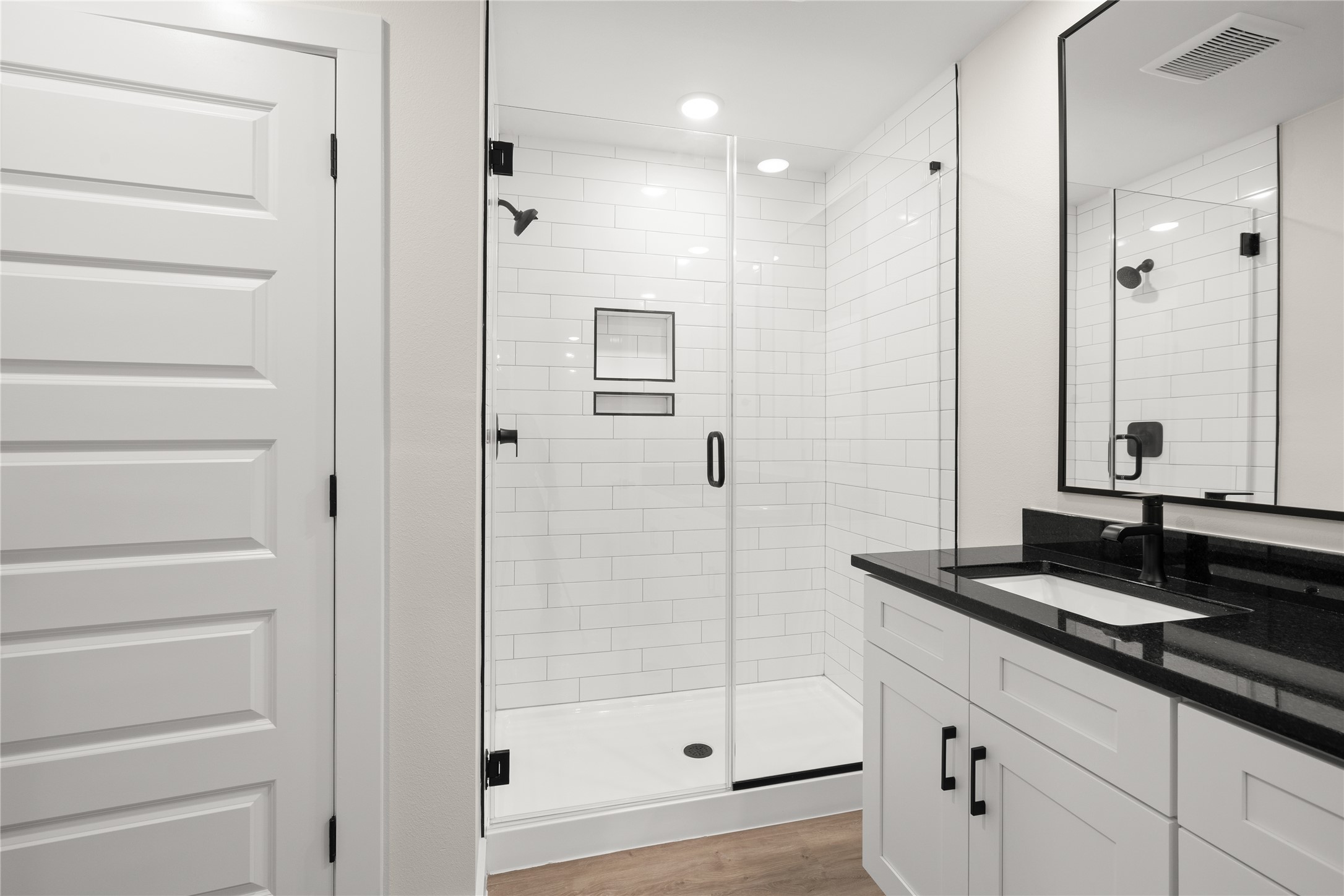 5514 Mobeetie Loop Bee Cave, TX 78738 - Photo 8 of 20 a bathroom with a granite countertop sink a mirror and shower
