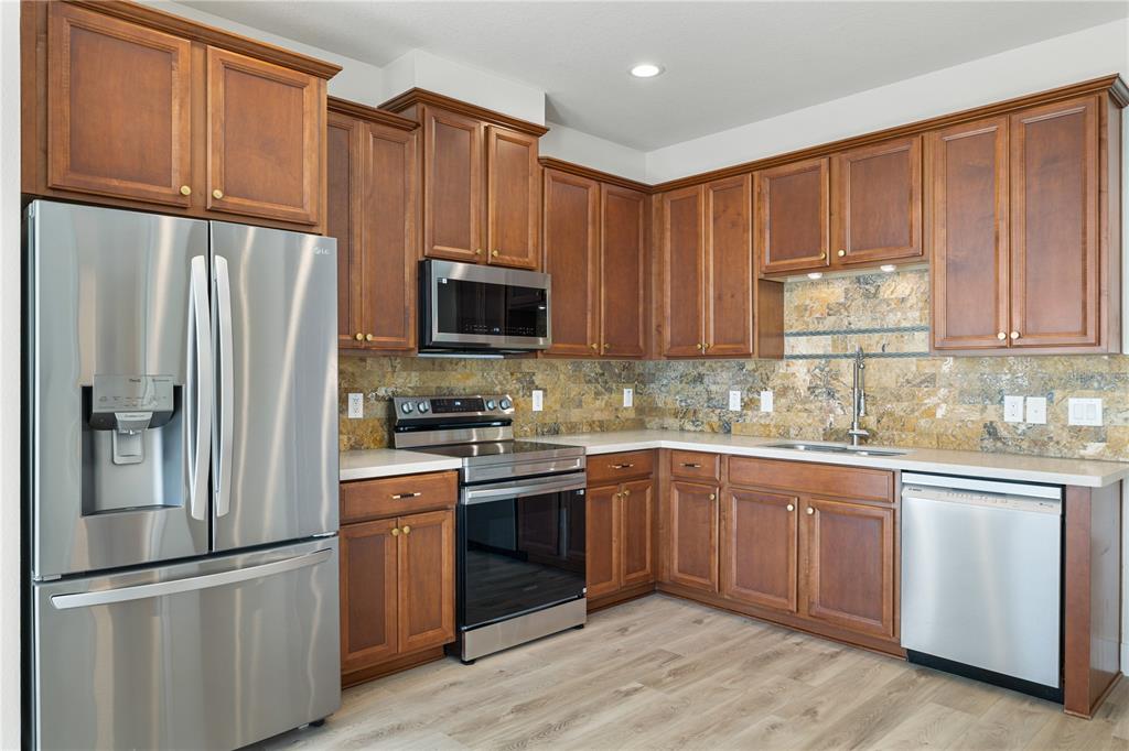 7819 Hardenton Street Windermere, FL 34786 - Photo 13 of 48 a kitchen with stainless steel appliances granite countertop a refrigerator stove microwave and sink