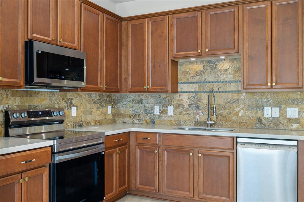 7819 Hardenton Street Windermere, FL 34786 - Photo 15 of 48 a kitchen with granite countertop stainless steel appliances white cabinets sink and a granite counter top