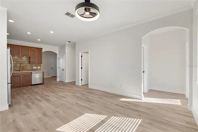a view of a kitchen with a sink and a refrigerator