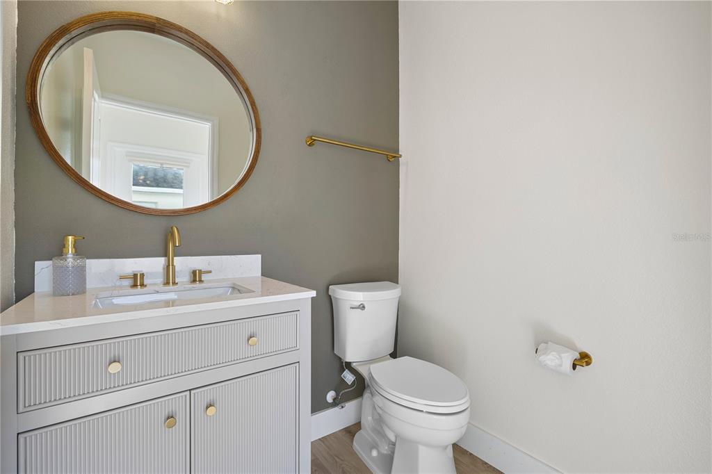 7819 Hardenton Street Windermere, FL 34786 - Photo 20 of 48 a bathroom with a toilet a sink and a mirror