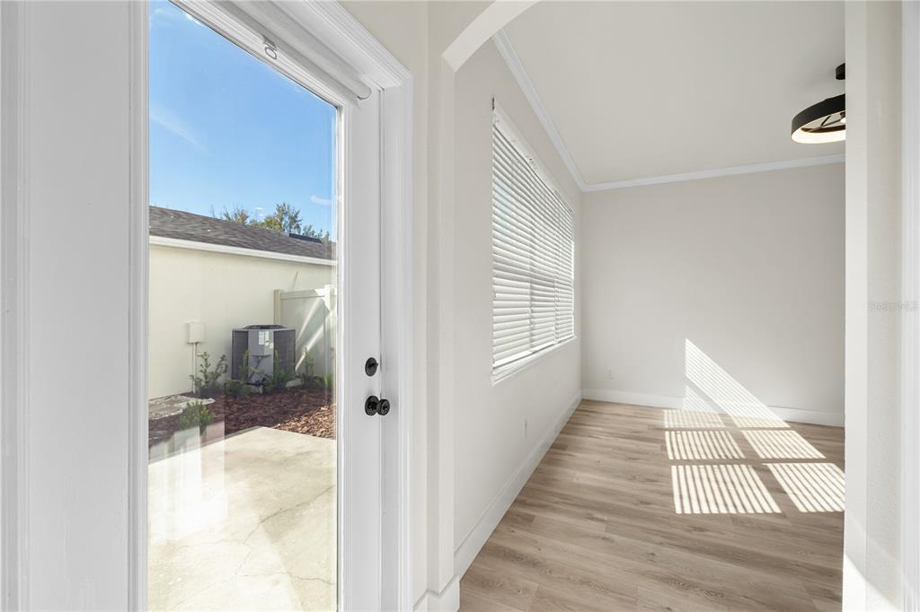 7819 Hardenton Street Windermere, FL 34786 - Photo 21 of 48 a view of a hallway with a livingroom and a bathroom with bathtub