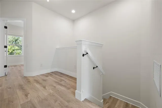 a view of hallway with wooden floor
