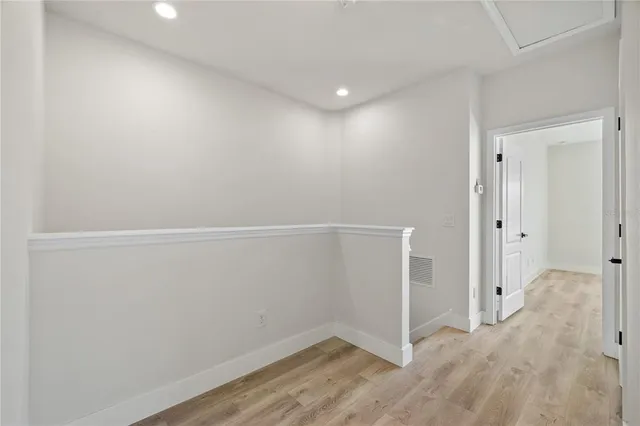 a view of walk in closet with wooden floor