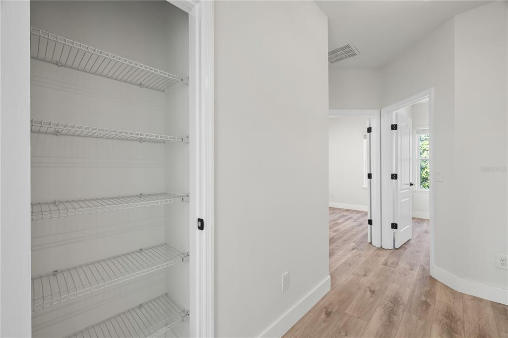 7819 Hardenton Street Windermere, FL 34786 - Photo 30 of 48 a view of walk in closet with wooden floor