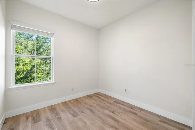 a view of a room with wooden floor