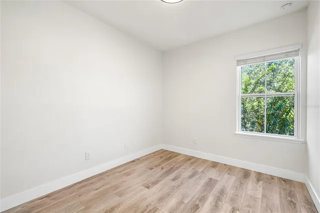 a view of an empty room and wooden floor