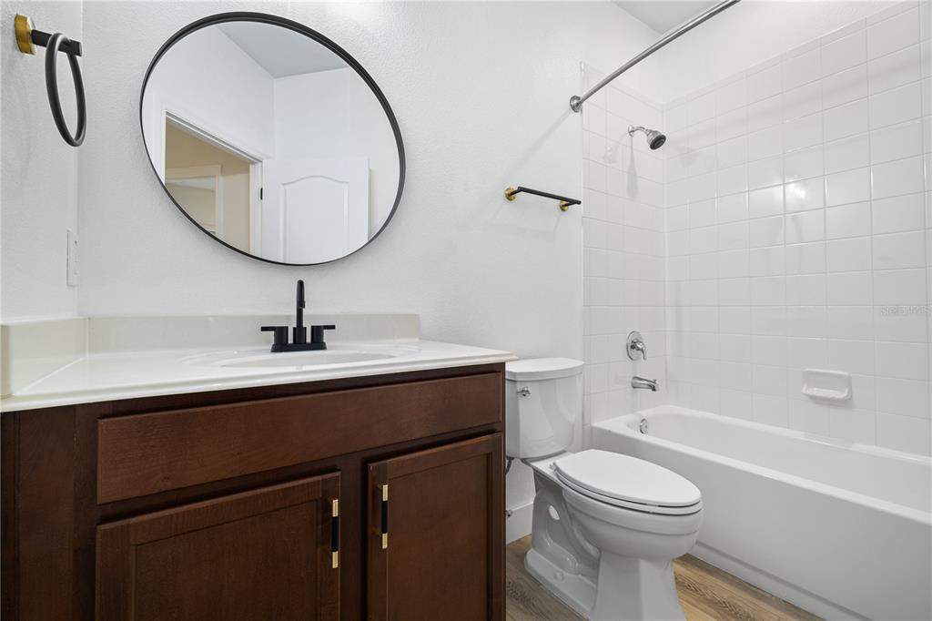 7819 Hardenton Street Windermere, FL 34786 - Photo 36 of 48 a bathroom with a sink a toilet and a mirror