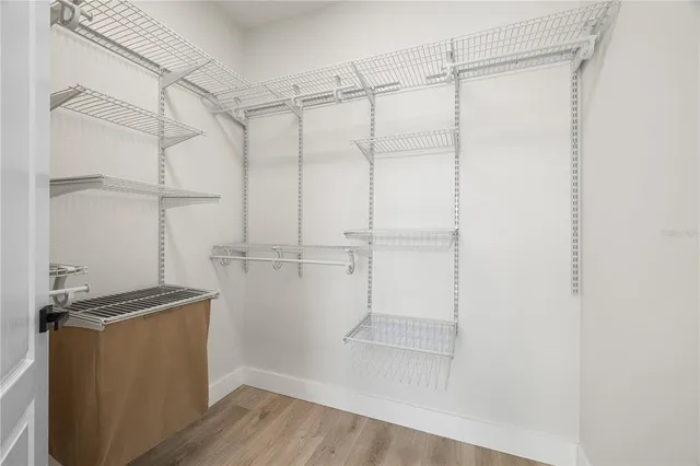 a view of walk in closet with empty racks