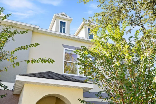 a front view of a house with trees