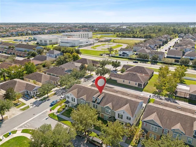 an aerial view of residential houses with outdoor space