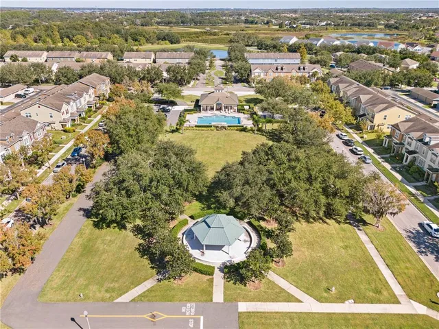 an aerial view of a house with a yard and lake view
