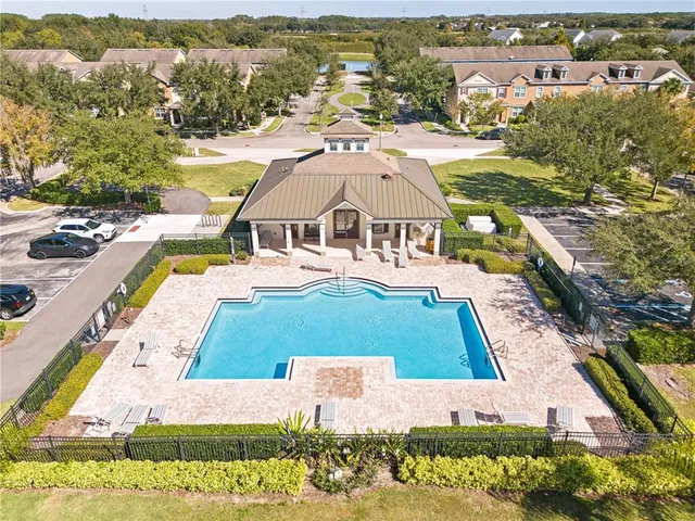 an aerial view of multiple houses with a swimming pool