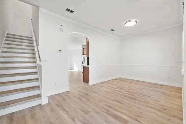 a view of a room with wooden floor and white walls