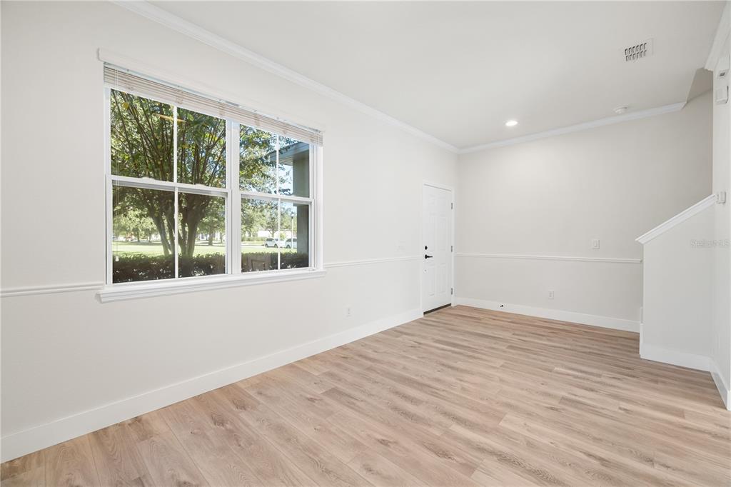7819 Hardenton Street Windermere, FL 34786 - Photo 8 of 48 a view of an empty room with wooden floor and a window