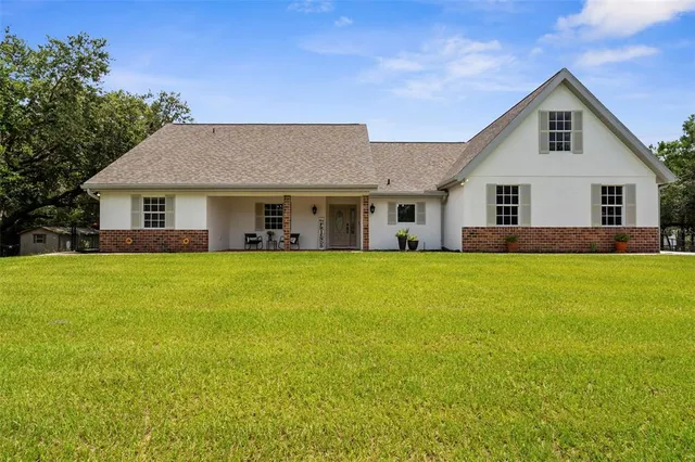 a front view of house with yard and green space