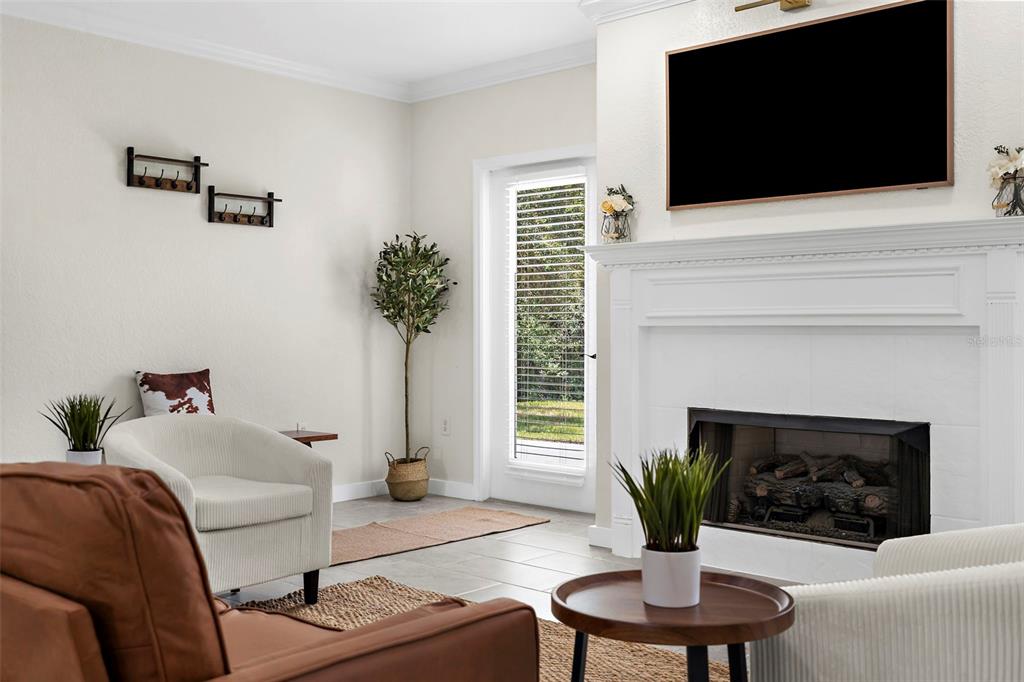 18355 Highway 62 Parrish, FL 34219 - Photo 11 of 50 a living room with furniture a fireplace and a flat screen tv