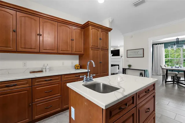 a kitchen with a sink a stove and cabinets