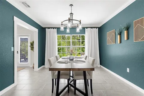 a dining room with furniture window and outside view