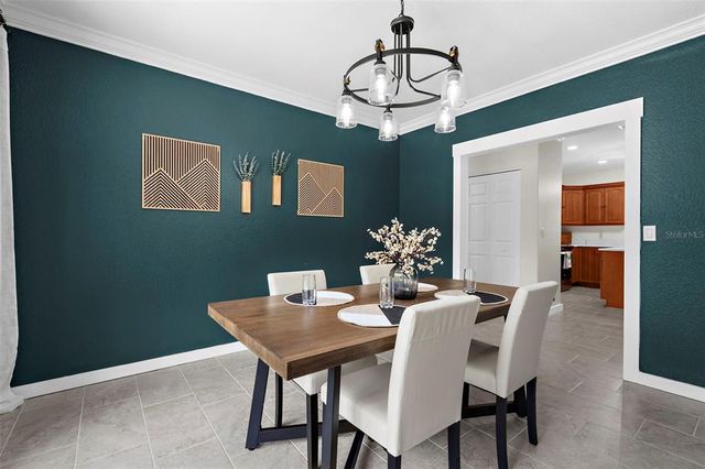 a view of a dining room with furniture wooden floor and a chandelier