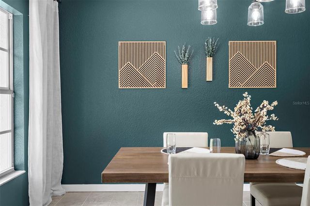 a dining room with furniture and wooden floor