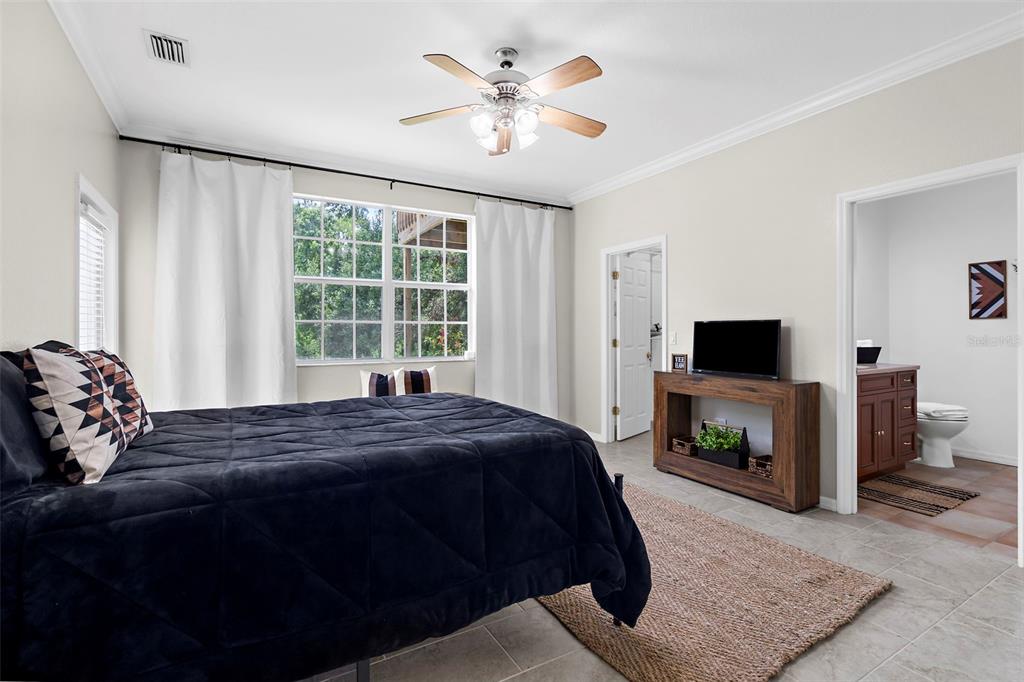 18355 Highway 62 Parrish, FL 34219 - Photo 22 of 50 a bedroom with a bed and a television