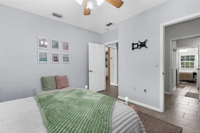 a bedroom with a bed and painting on the wall