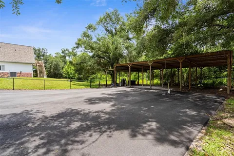 a view of a house with a yard and sitting area