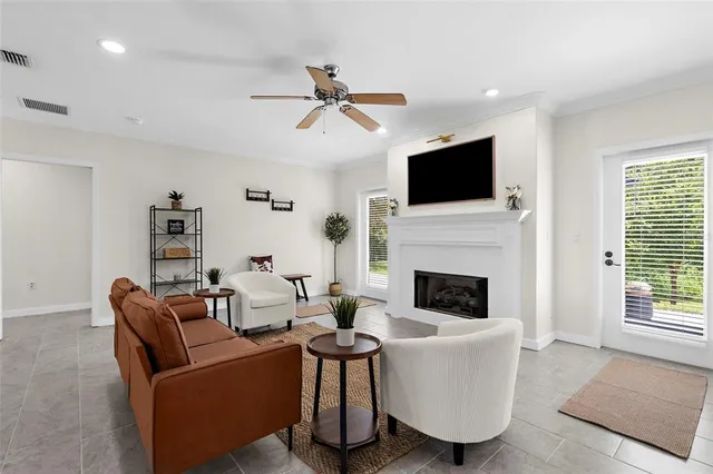 a living room with furniture a fireplace and a flat screen tv