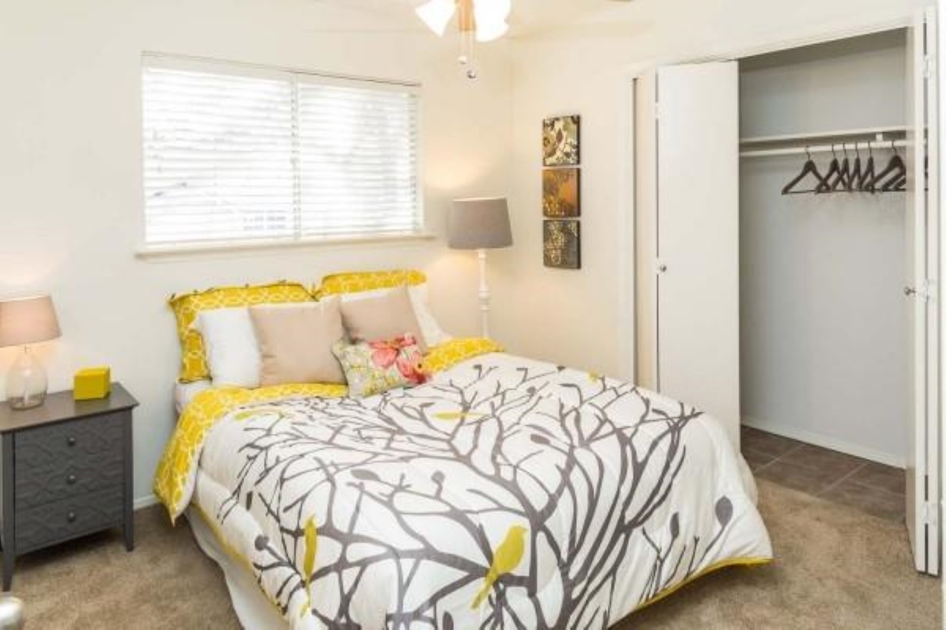 3405 Helms Street, Unit 109 Austin, TX 78705 - Photo 5 of 6 Bedroom showcasing the ceiling fan, closet, and carpet floors