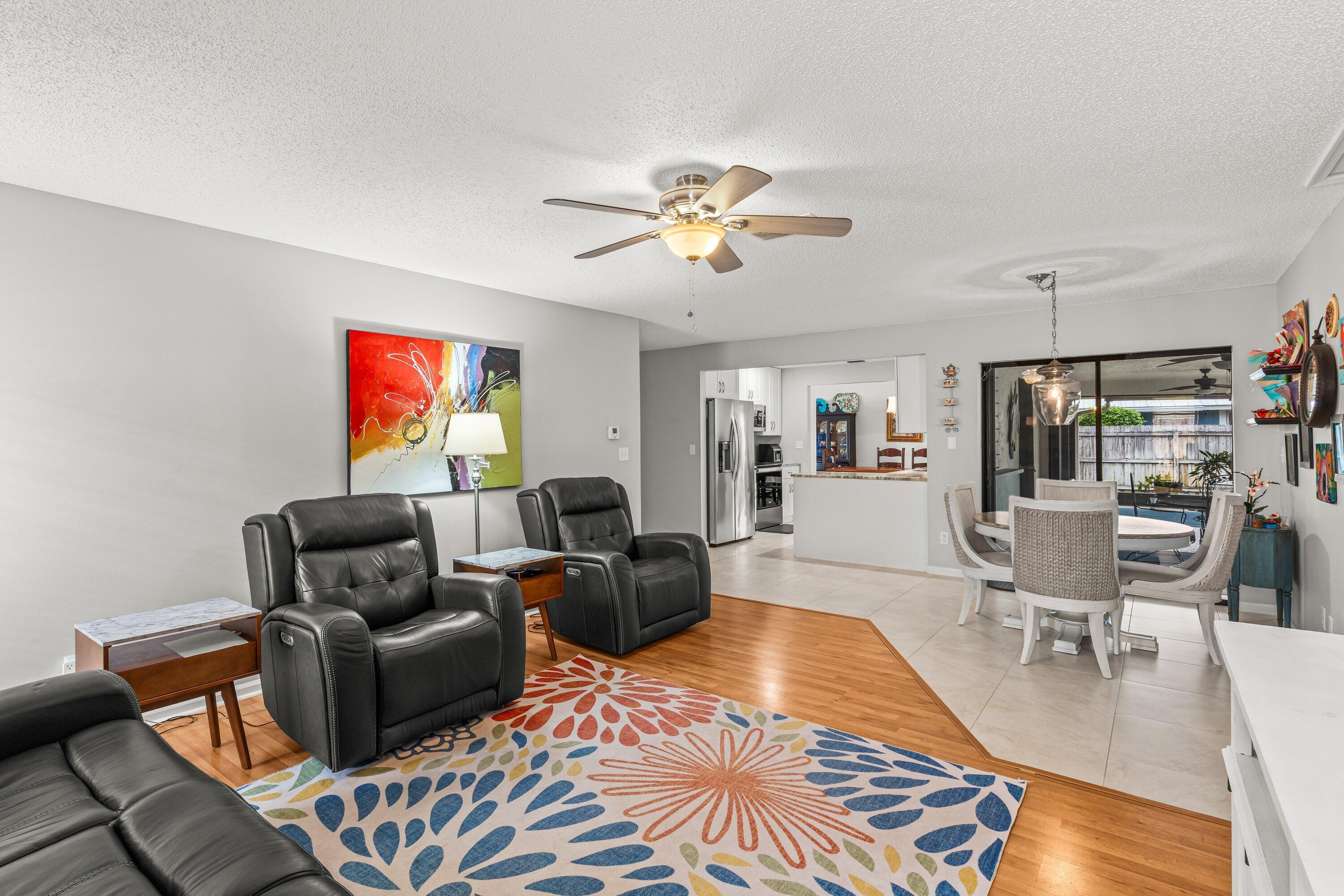 13795 Geranium Place Wellington, FL 33414 - Photo 13 of 37 a living room with furniture a flat screen tv and kitchen view