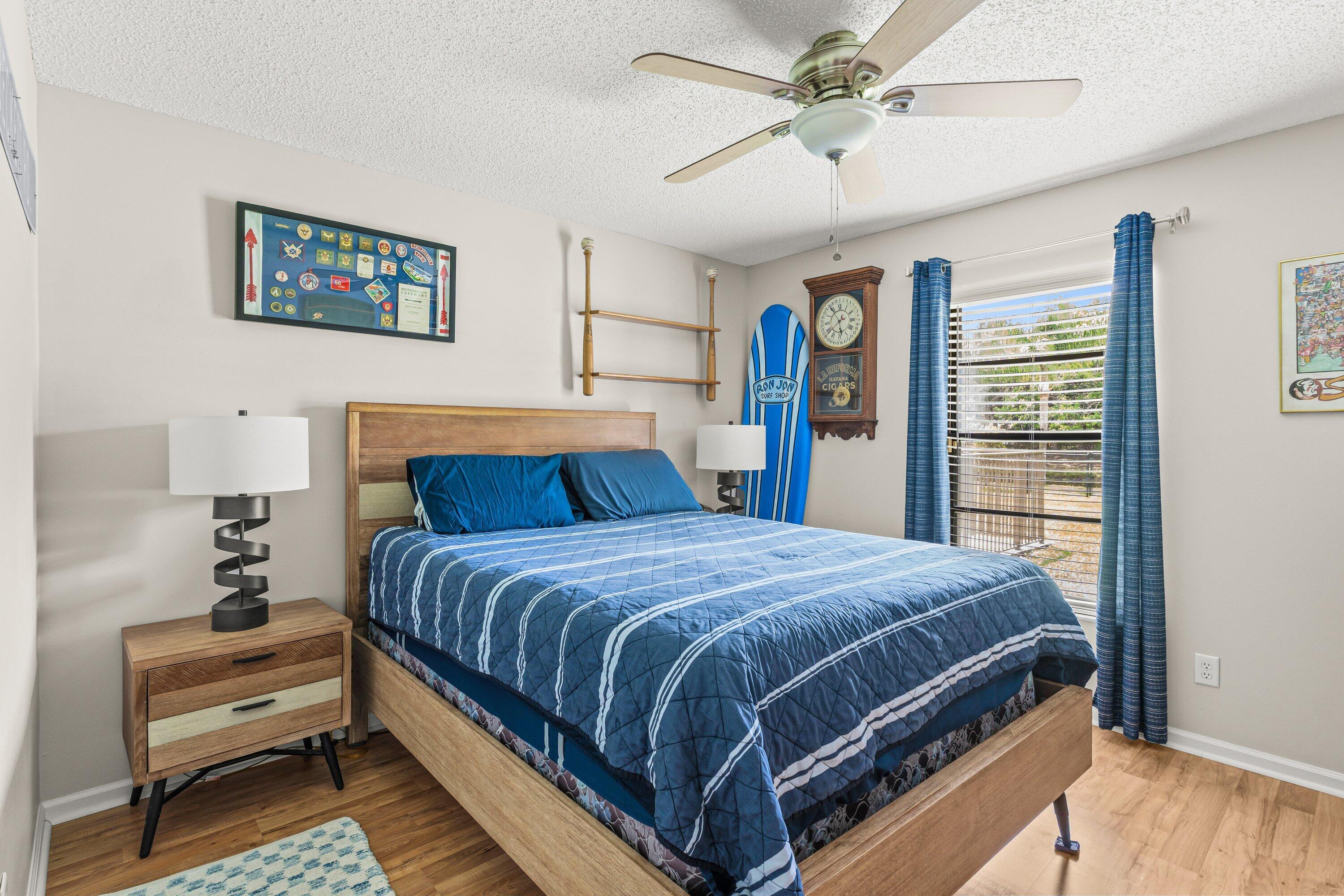 13795 Geranium Place Wellington, FL 33414 - Photo 16 of 37 a bedroom with a large bed and a chandelier