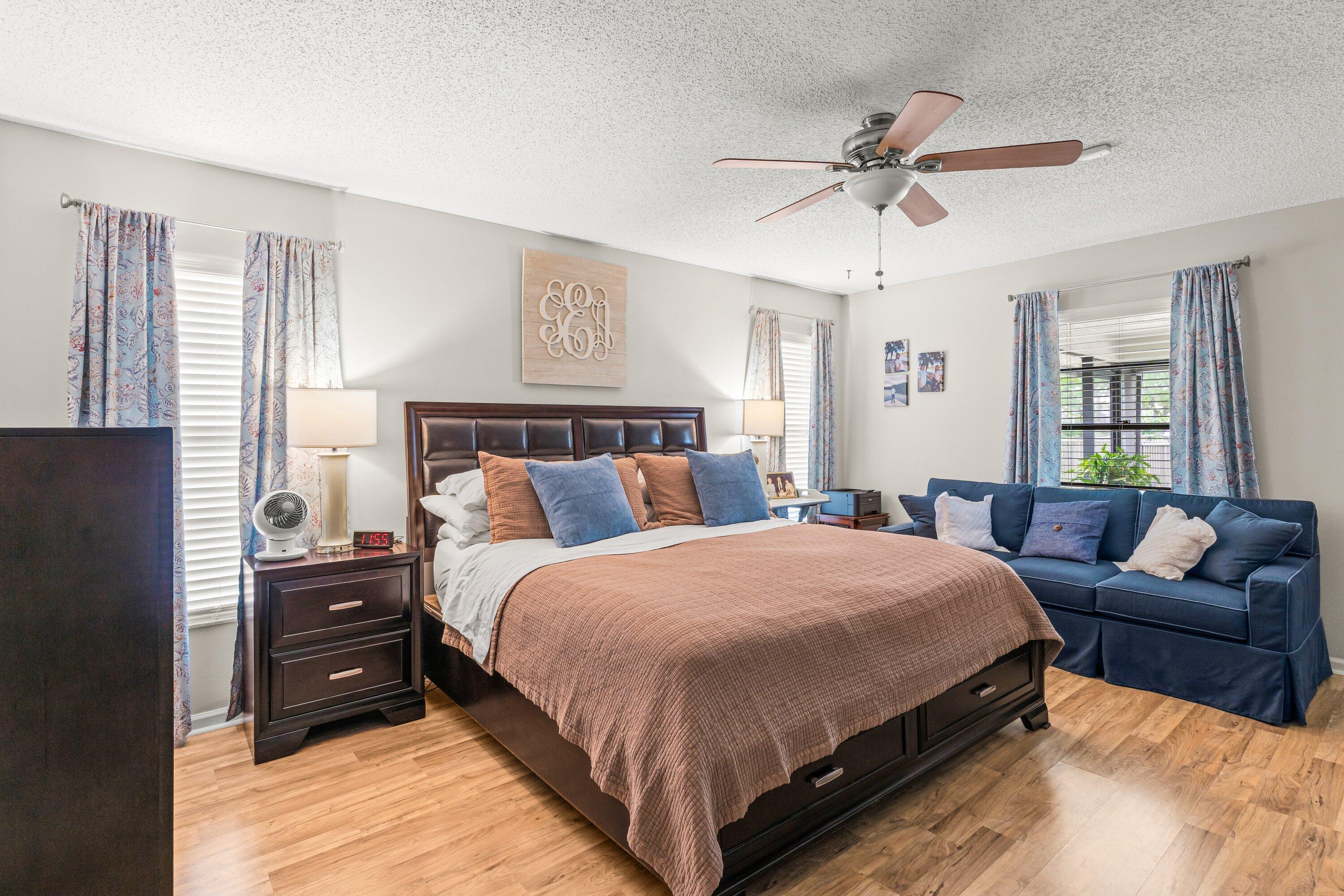 13795 Geranium Place Wellington, FL 33414 - Photo 19 of 37 a bedroom with a bed a chandelier and a couch
