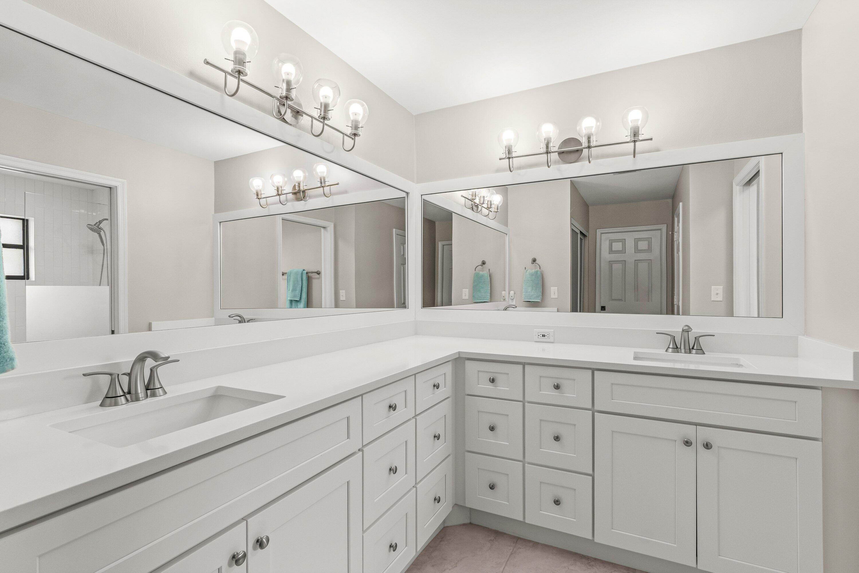 13795 Geranium Place Wellington, FL 33414 - Photo 20 of 37 a bathroom with double sink and a mirror