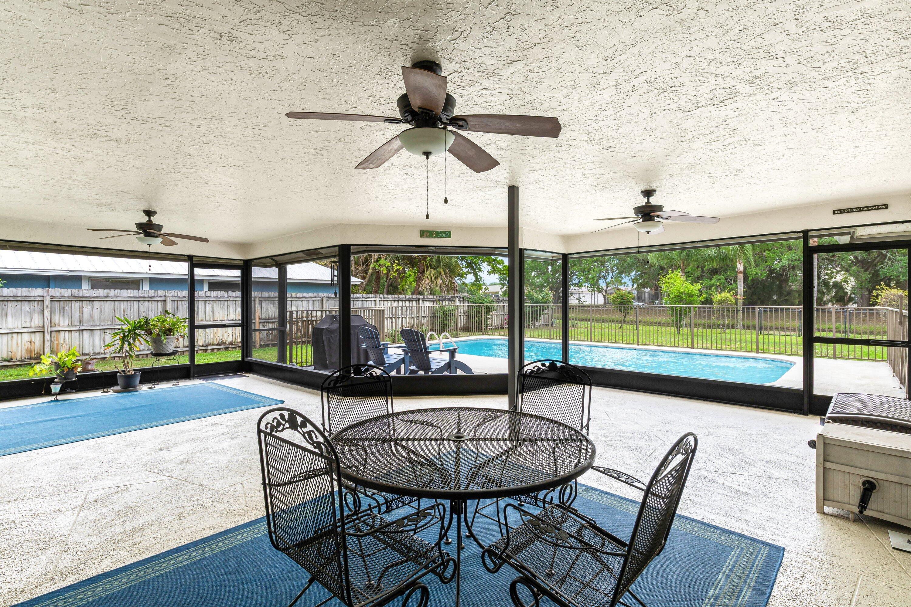 13795 Geranium Place Wellington, FL 33414 - Photo 22 of 37 a living room with furniture and a floor to ceiling window