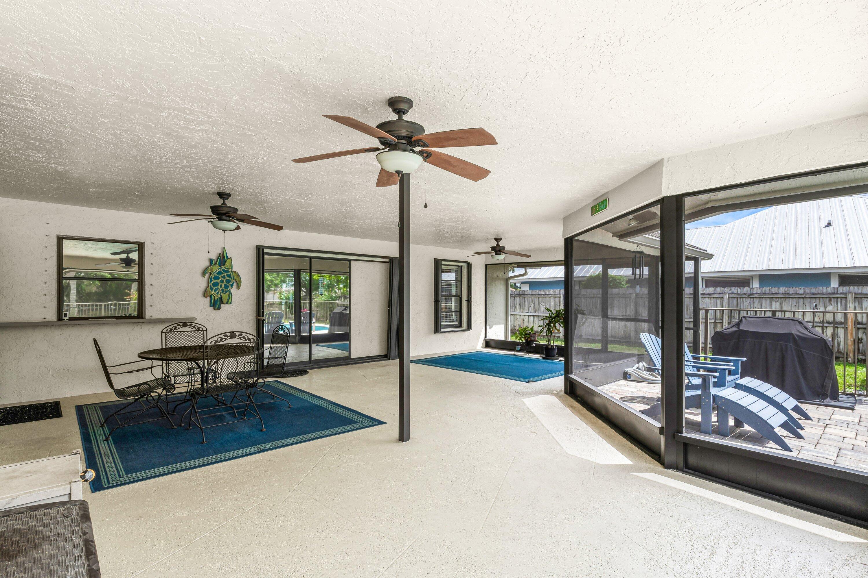 13795 Geranium Place Wellington, FL 33414 - Photo 24 of 37 a living room with furniture a ceiling fan and a fireplace